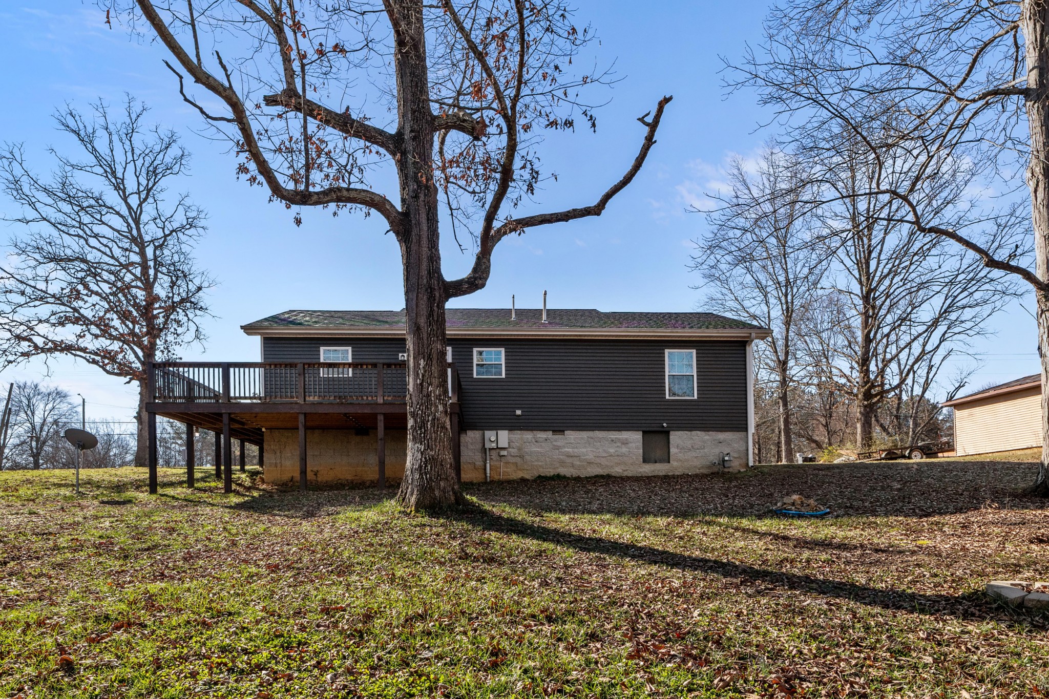358 Able Street Big Sandy, TN 38221 - Photo 8 of 31 a house that has a tree in front of it