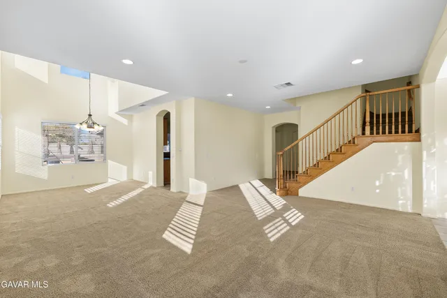 a large white kitchen with a large window