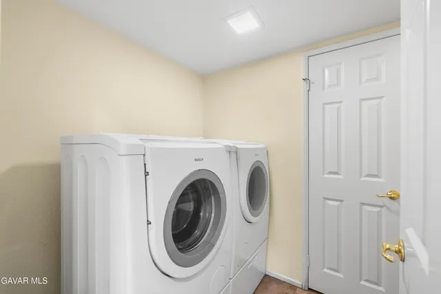 a spacious bathroom with a double vanity sink a mirror and a bathtub