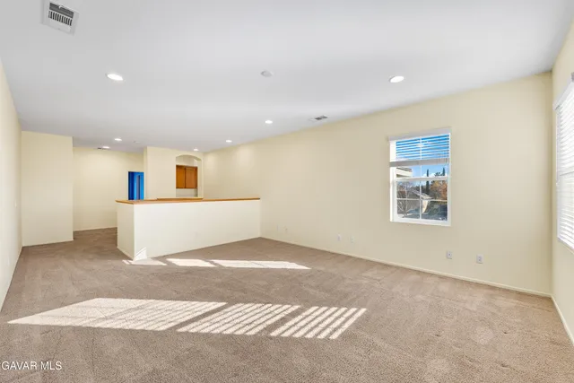 a bathroom with a granite countertop tub shower and mirror