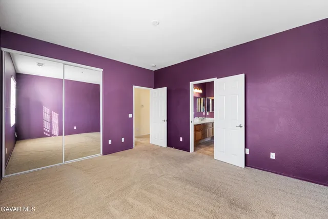 a view of a patio with a table and chairs under an umbrella