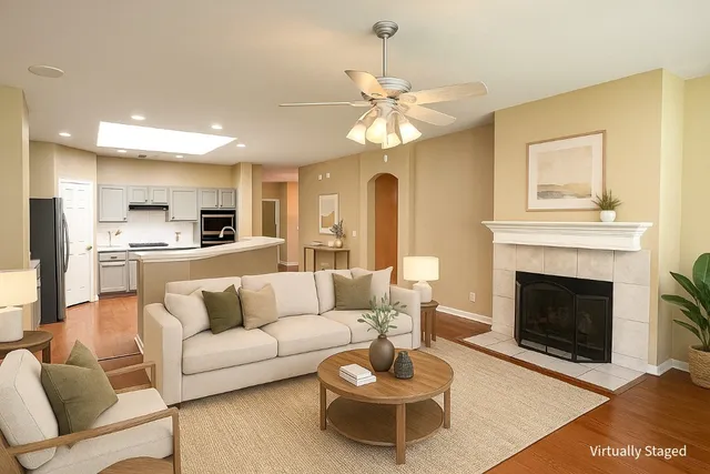 a living room with furniture kitchen view and a fireplace