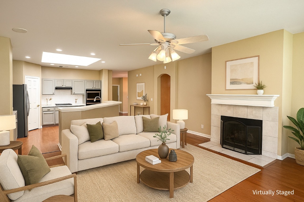 Living room with fireplace and kitchen with island.
