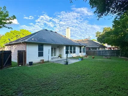 a front view of a house with a garden and patio