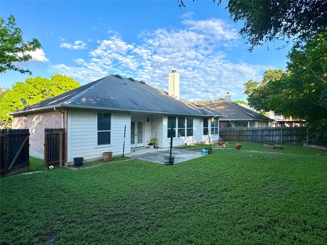 a front view of a house with a garden and patio