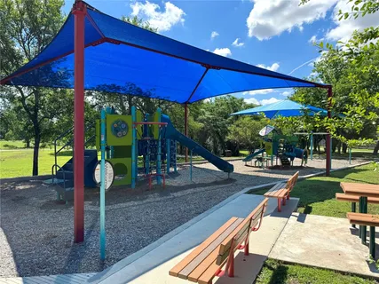 a view of a patio with a table and chairs under an umbrella