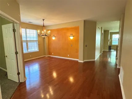 a view of a room with wooden floor and door