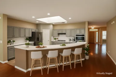 a kitchen with kitchen island granite countertop wooden cabinets and center island