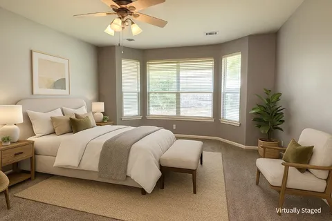 a spacious bedroom with a bed and a couch