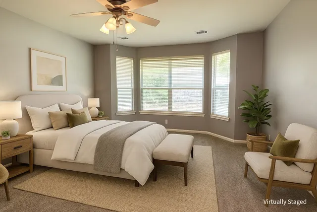 a spacious bedroom with a bed and a couch