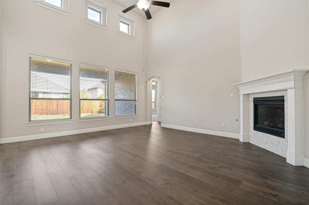 2802 Merlot Circle Rowlett, TX 75088 - Photo 7 of 40 an empty room with wooden floor cabinet and windows