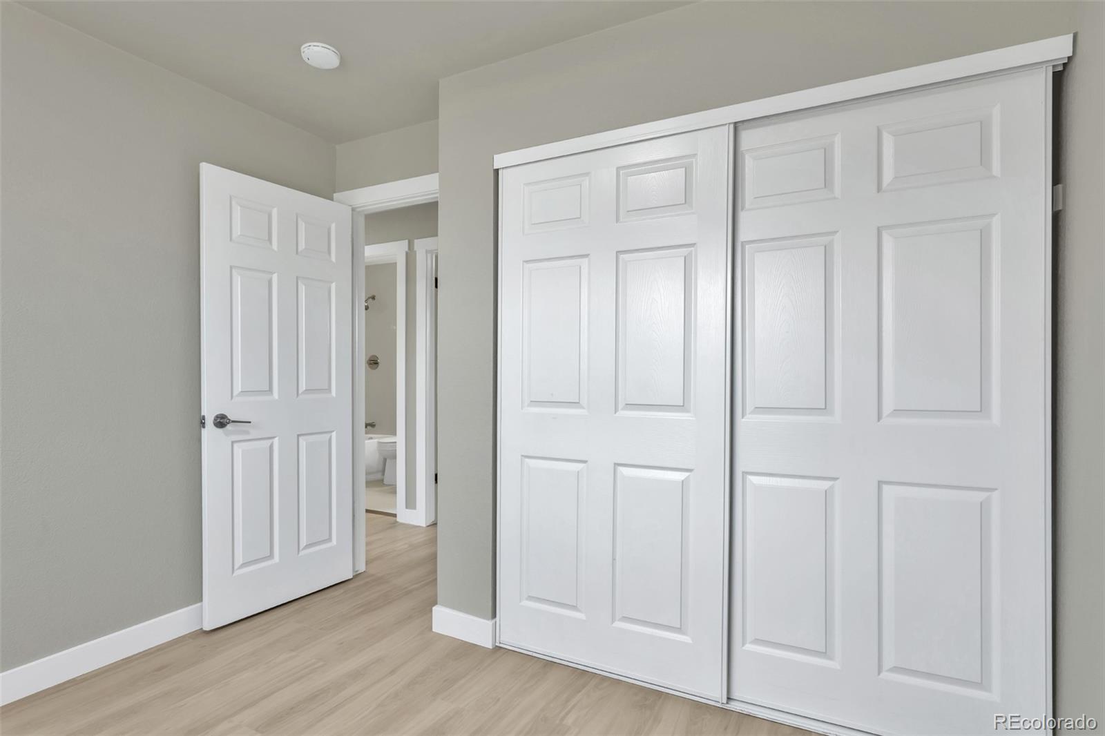 2787 South Helena Way Aurora, CO 80013 - Photo 12 of 26 an empty room with wooden floor