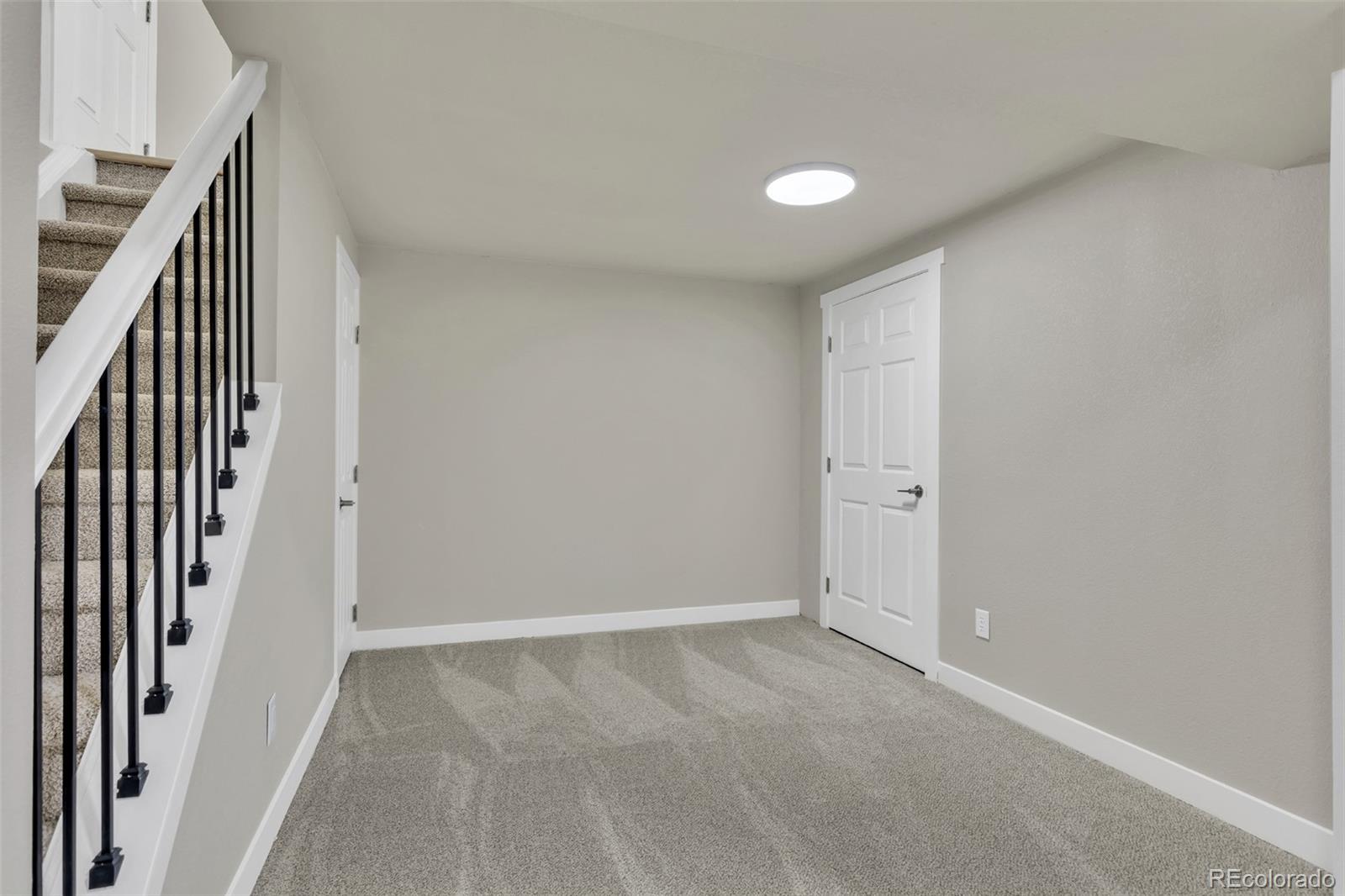 2787 South Helena Way Aurora, CO 80013 - Photo 19 of 26 an empty room with wooden floor and windows