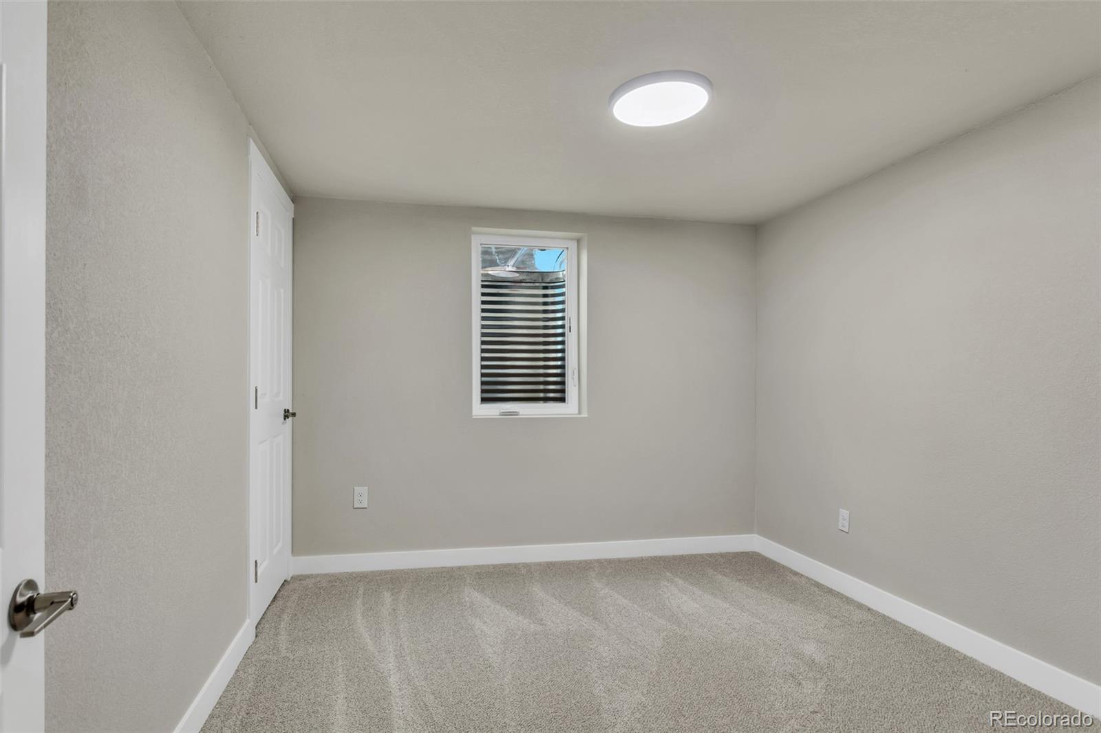 2787 South Helena Way Aurora, CO 80013 - Photo 22 of 26 a view of an empty room with a window