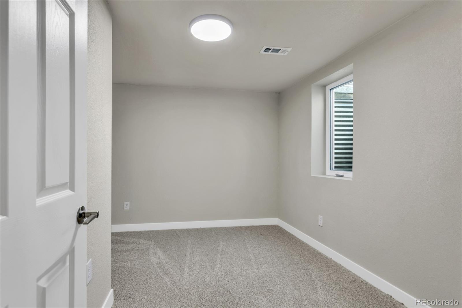 2787 South Helena Way Aurora, CO 80013 - Photo 23 of 26 a view of an empty room with a window