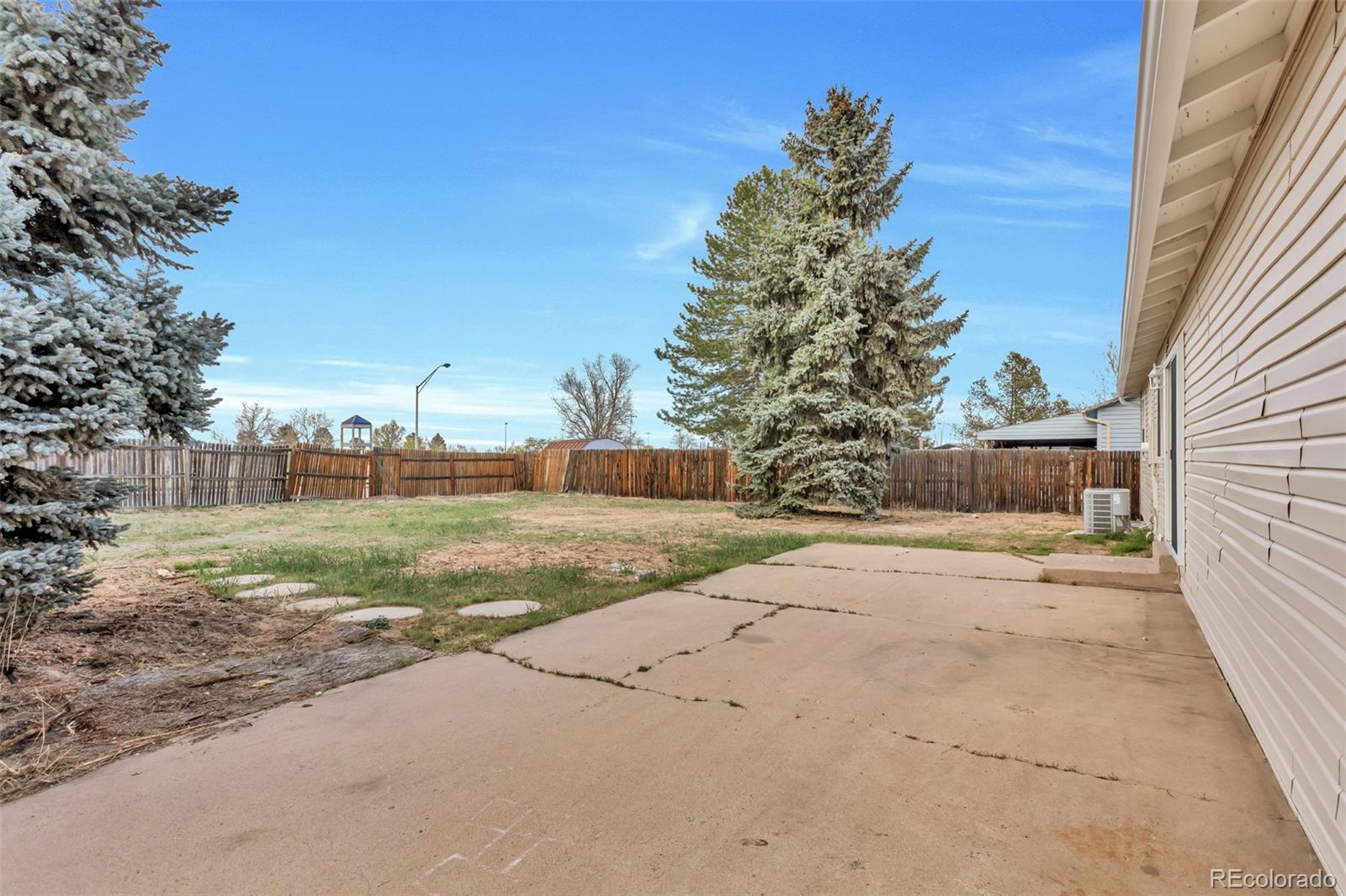 2787 South Helena Way Aurora, CO 80013 - Photo 25 of 26 a view of a yard with potted plants