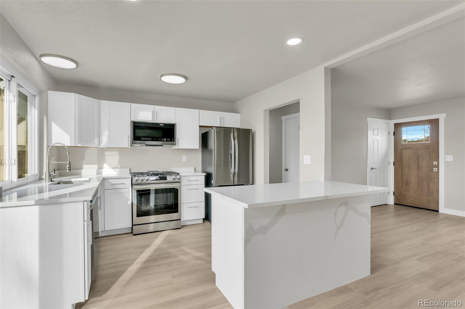 2787 South Helena Way Aurora, CO 80013 - Photo 8 of 26 a large kitchen with cabinets and stainless steel appliances