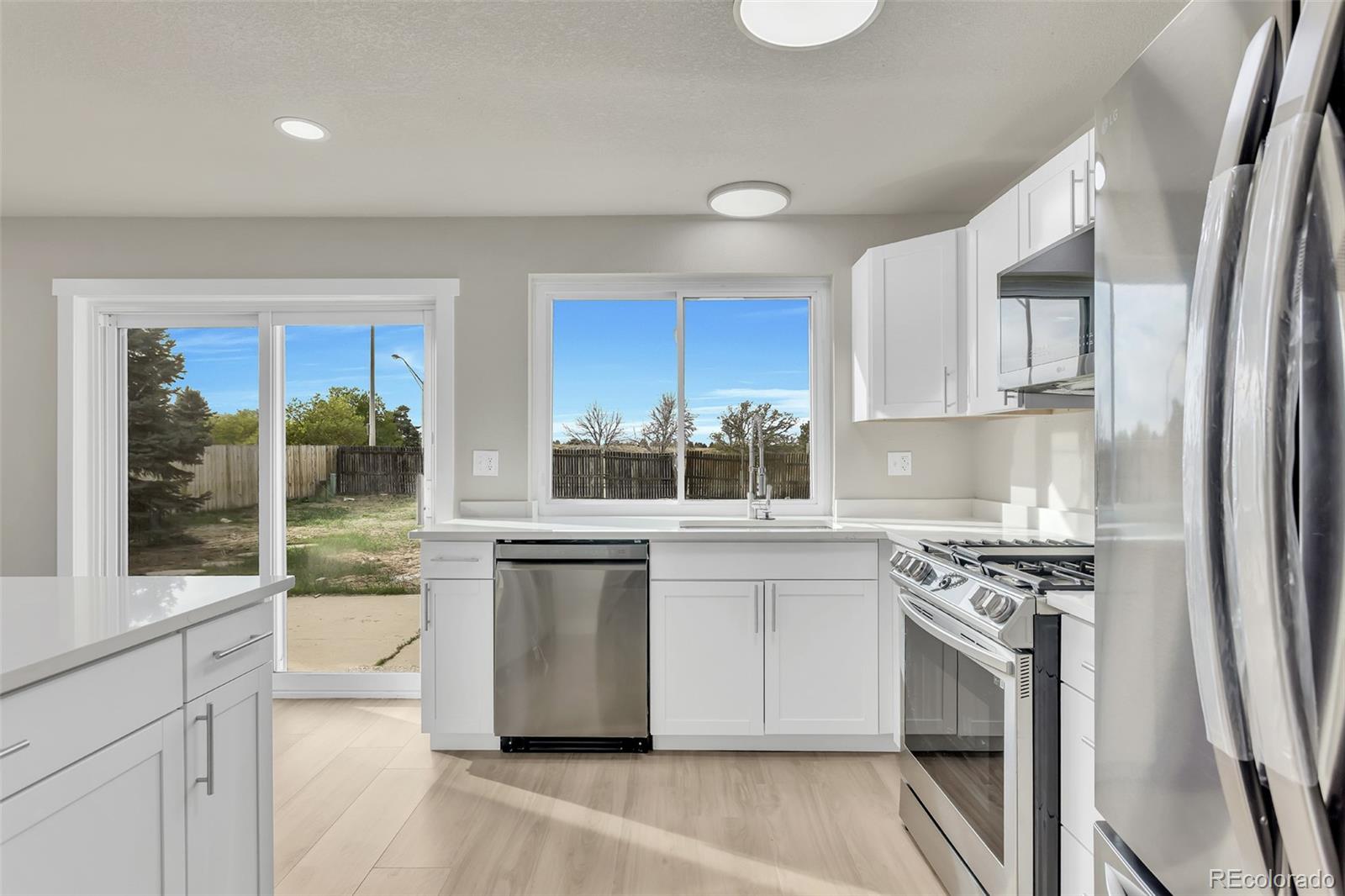 2787 South Helena Way Aurora, CO 80013 - Photo 9 of 26 a kitchen with stainless steel appliances granite countertop a stove a sink and a refrigerator