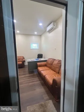 a living room with a couch and a next to a window