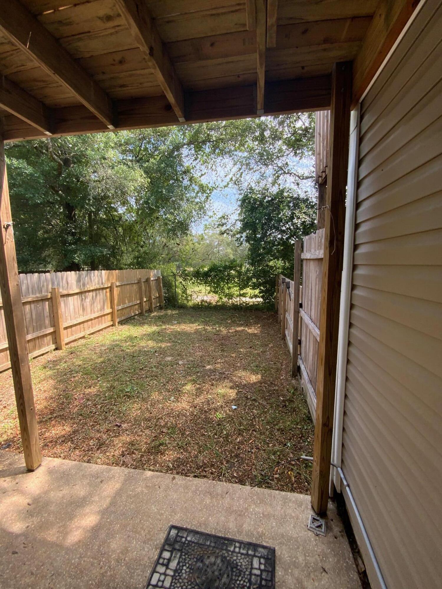 830 Shadow Lane Fort Walton Beach, FL 32547 - Photo 5 of 11 a view of a backyard with wooden fence