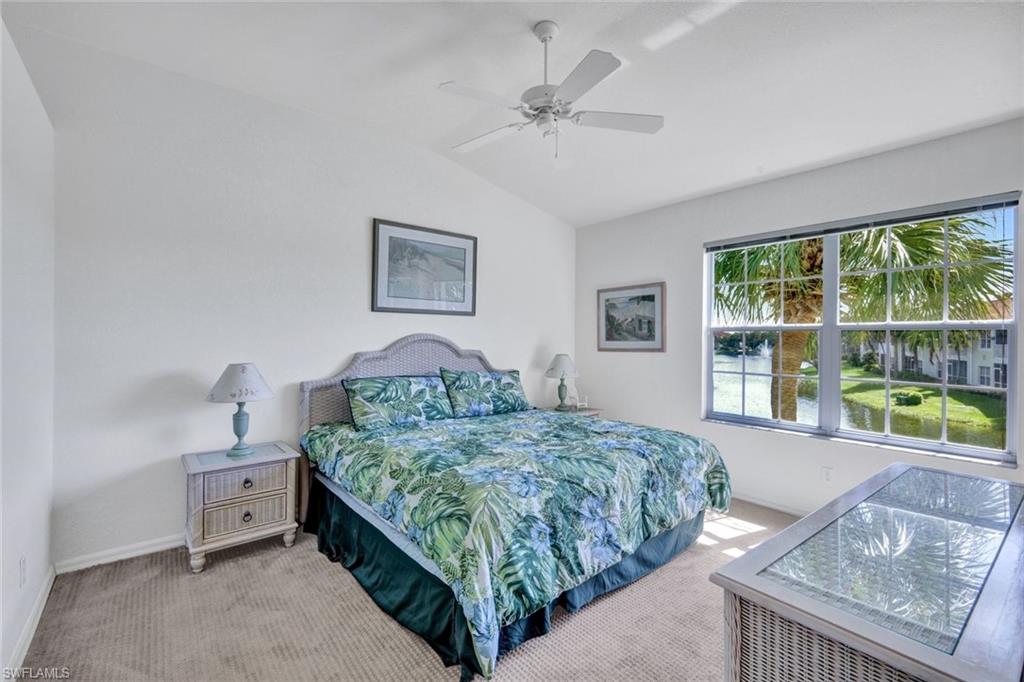 10711 Halfmoon Shoal Road, Unit 203 Estero, FL 34135 - Photo 13 of 25 a bedroom with a bed and a large window
