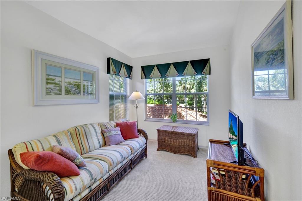 10711 Halfmoon Shoal Road, Unit 203 Estero, FL 34135 - Photo 17 of 25 a living room with furniture and a large window