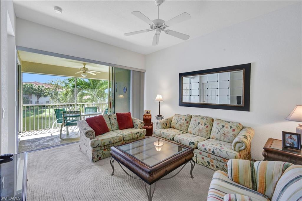 10711 Halfmoon Shoal Road, Unit 203 Estero, FL 34135 - Photo 3 of 25 a living room with furniture and a large window