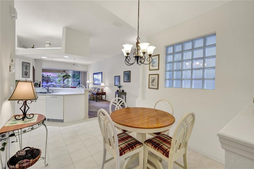 10711 Halfmoon Shoal Road, Unit 203 Estero, FL 34135 - Photo 7 of 25 a view of a dining room with furniture and chandelier