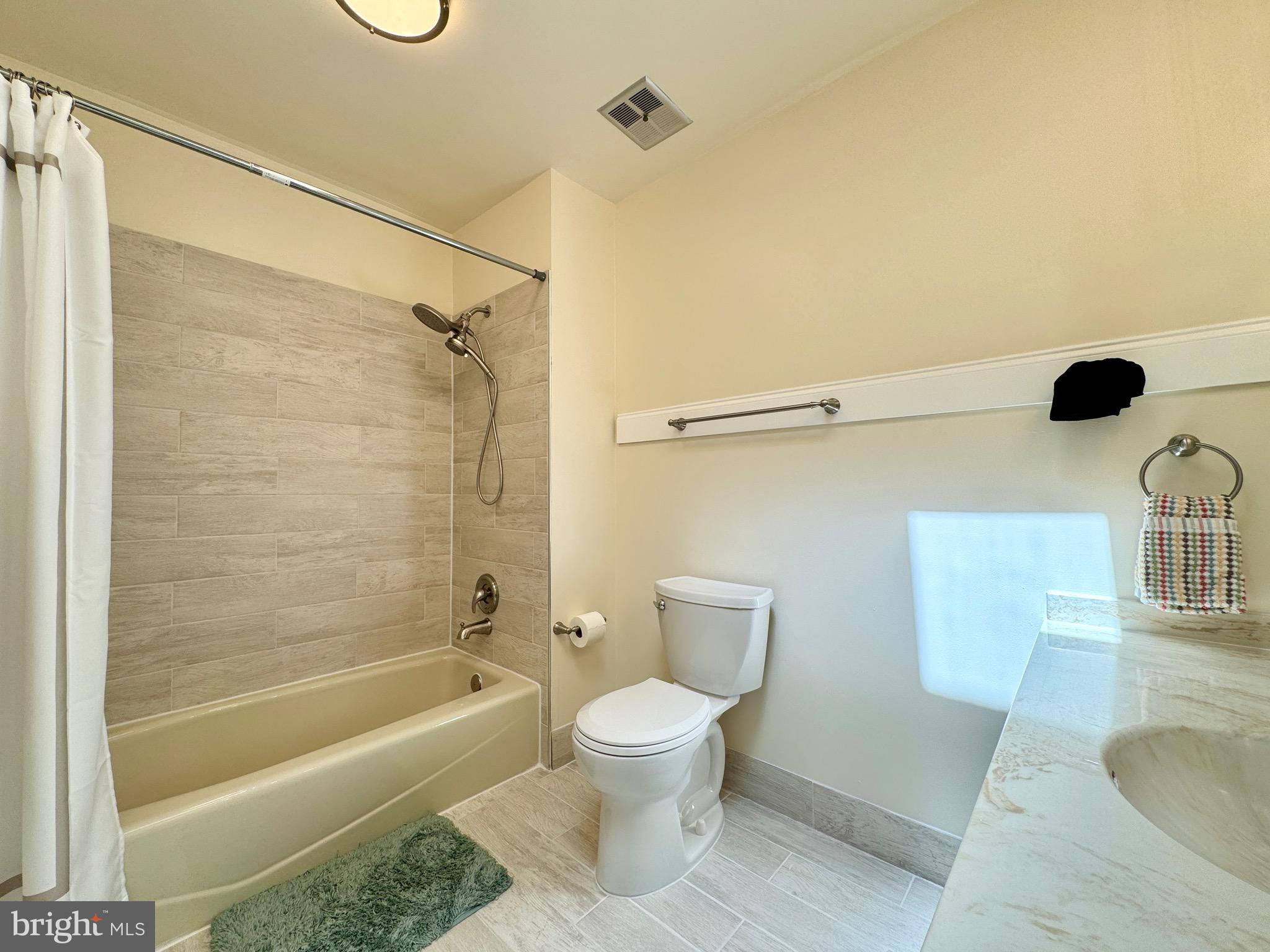 6728 Churchill Road McLean, VA 22101 - Photo 14 of 32 a bathroom with a toilet and a shower