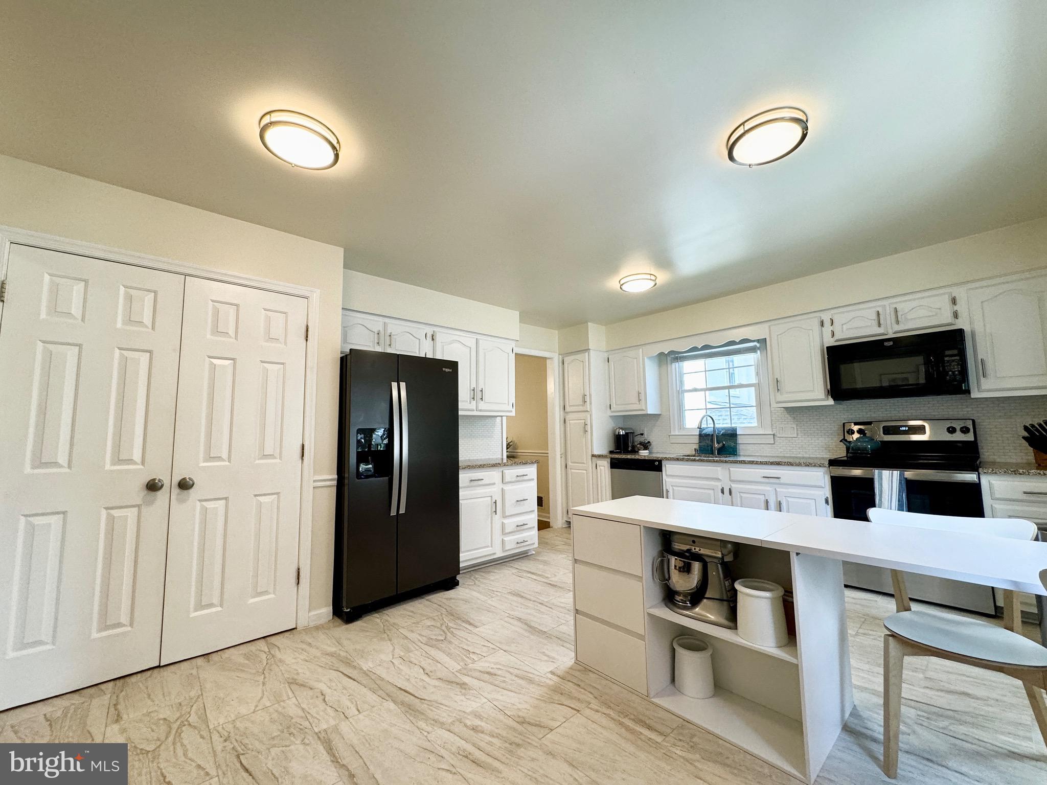 6728 Churchill Road McLean, VA 22101 - Photo 5 of 32 a kitchen with stainless steel appliances granite countertop a refrigerator stove and sink