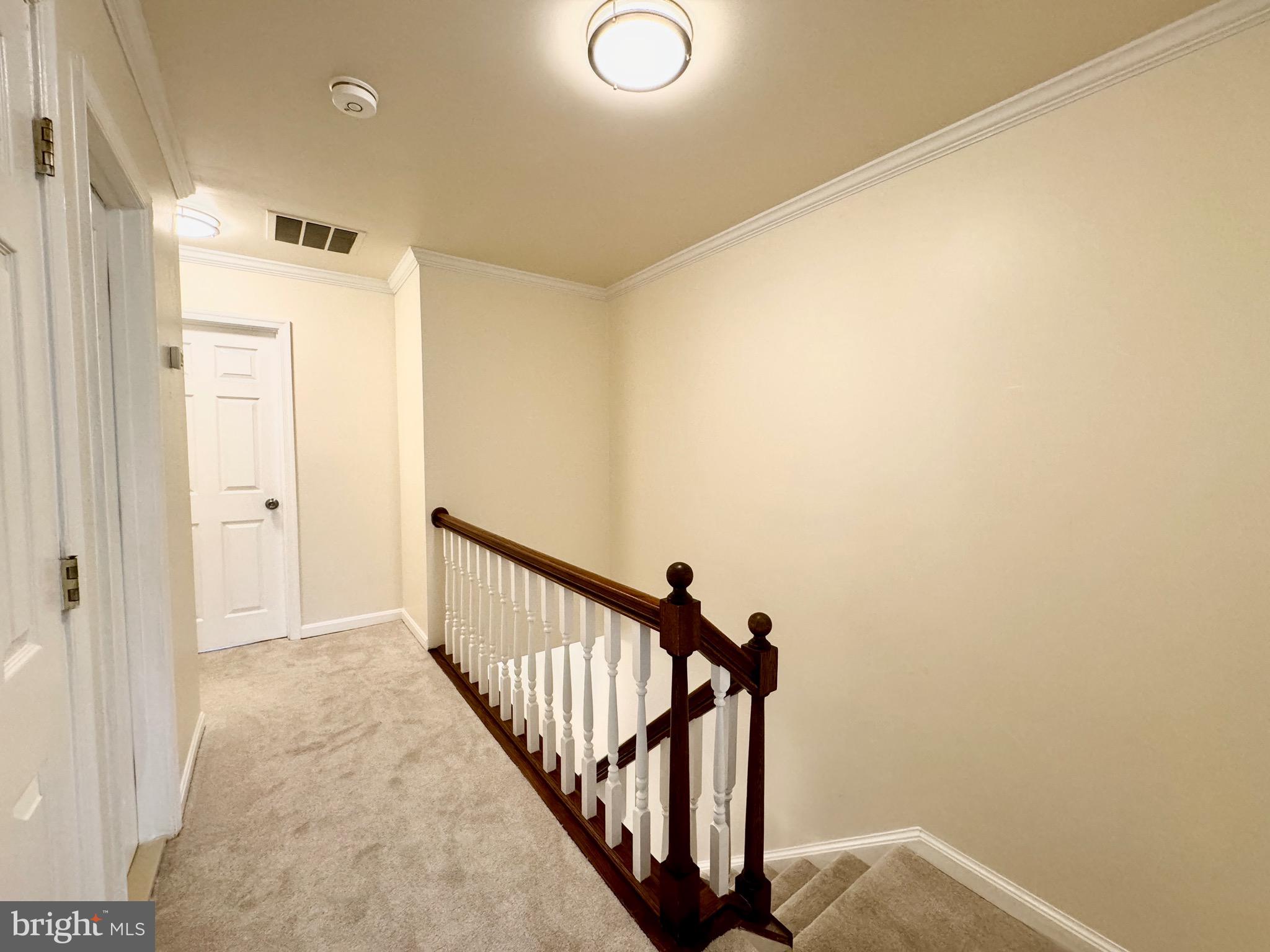 6728 Churchill Road McLean, VA 22101 - Photo 10 of 32 a view of a hallway with wooden floor and staircase