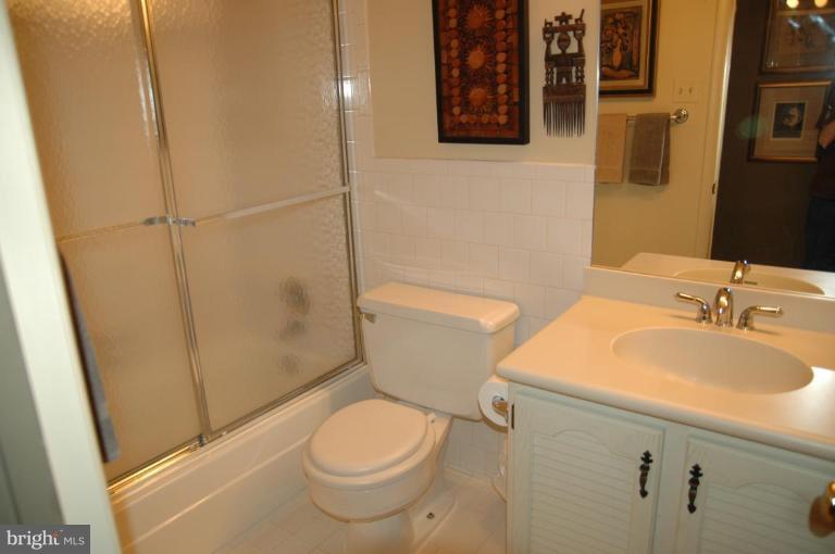 117 Cross Keys Road, Unit R117E Baltimore, MD 21210 - Photo 10 of 22 a bathroom with a sink a toilet and shower