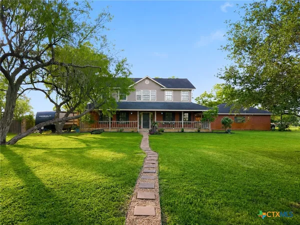 a front view of a house with a yard