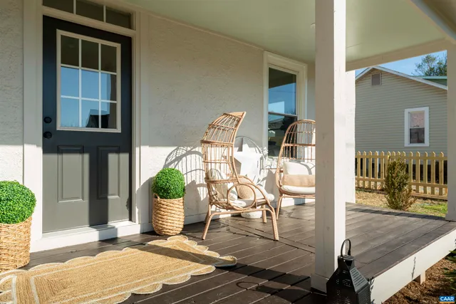 a living room with furniture a table and a potted plant