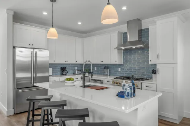 a kitchen with a sink and a large mirror