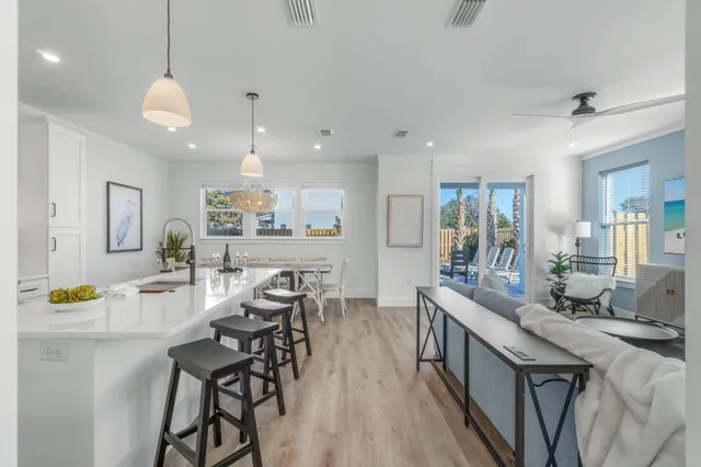 a living room with furniture a wooden floor and a large window