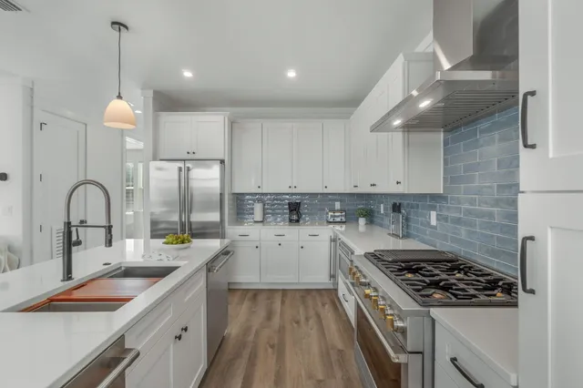 a living room with lots of furniture and kitchen view