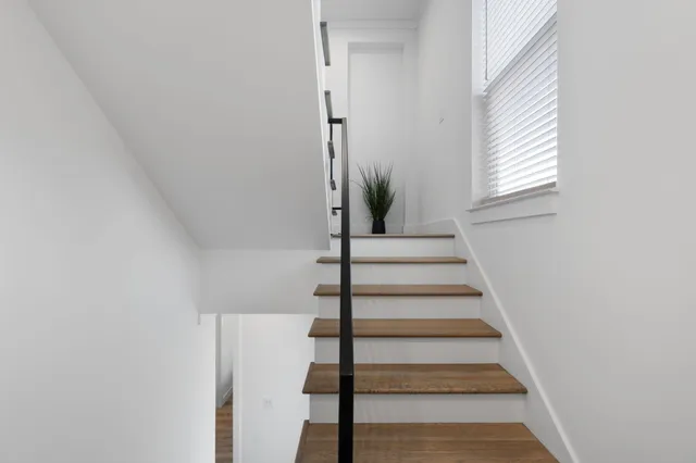 a very nice looking room with wooden floor and cabinets