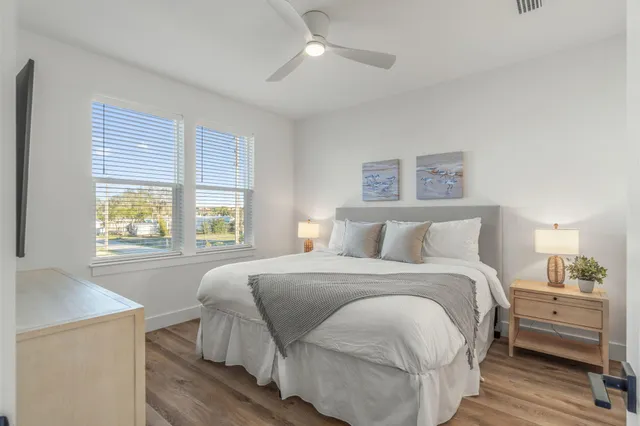 a bedroom with a large bed and a chandelier