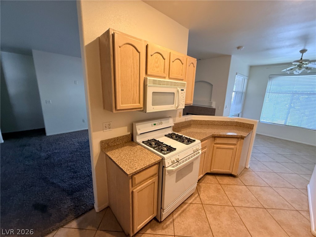 2050 West Warm Springs Road, Unit 3521 Henderson, NV 89014 - Photo 10 of 12 Functional kitchen with ample counter space and appliances, ready for culinary endeavors.