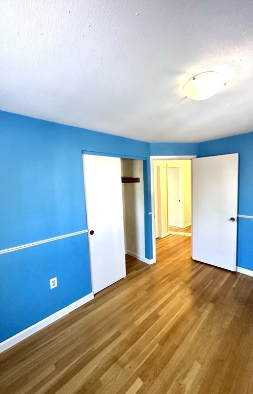 24 Seneca Drive Hudson, MA 01749 - Photo 15 of 30 an empty room with wooden floor and windows