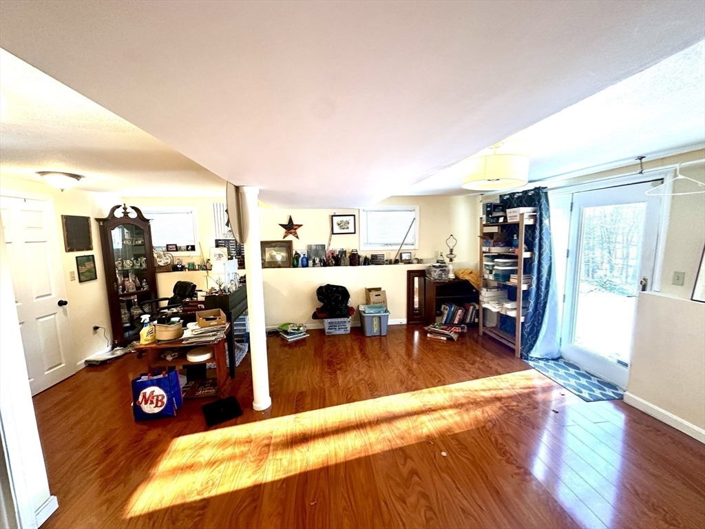 24 Seneca Drive Hudson, MA 01749 - Photo 20 of 30 a view of a living room with furniture and a flat screen tv