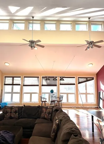 a view of a dining room with furniture large windows and wooden floor