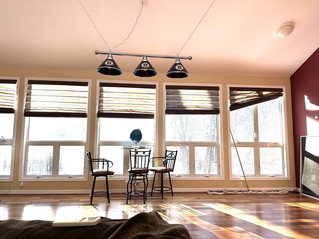 24 Seneca Drive Hudson, MA 01749 - Photo 6 of 30 a view of a dining room with furniture large windows and wooden floor