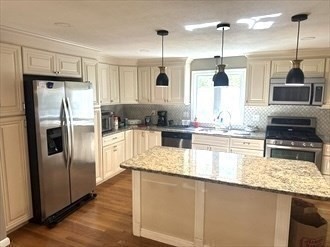 24 Seneca Drive Hudson, MA 01749 - Photo 10 of 30 a kitchen with stainless steel appliances granite countertop a refrigerator a oven and a sink