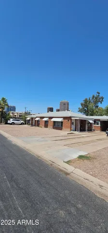 a view of a big house with a big yard and large trees