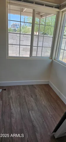 a view of a room with wooden floor and windows