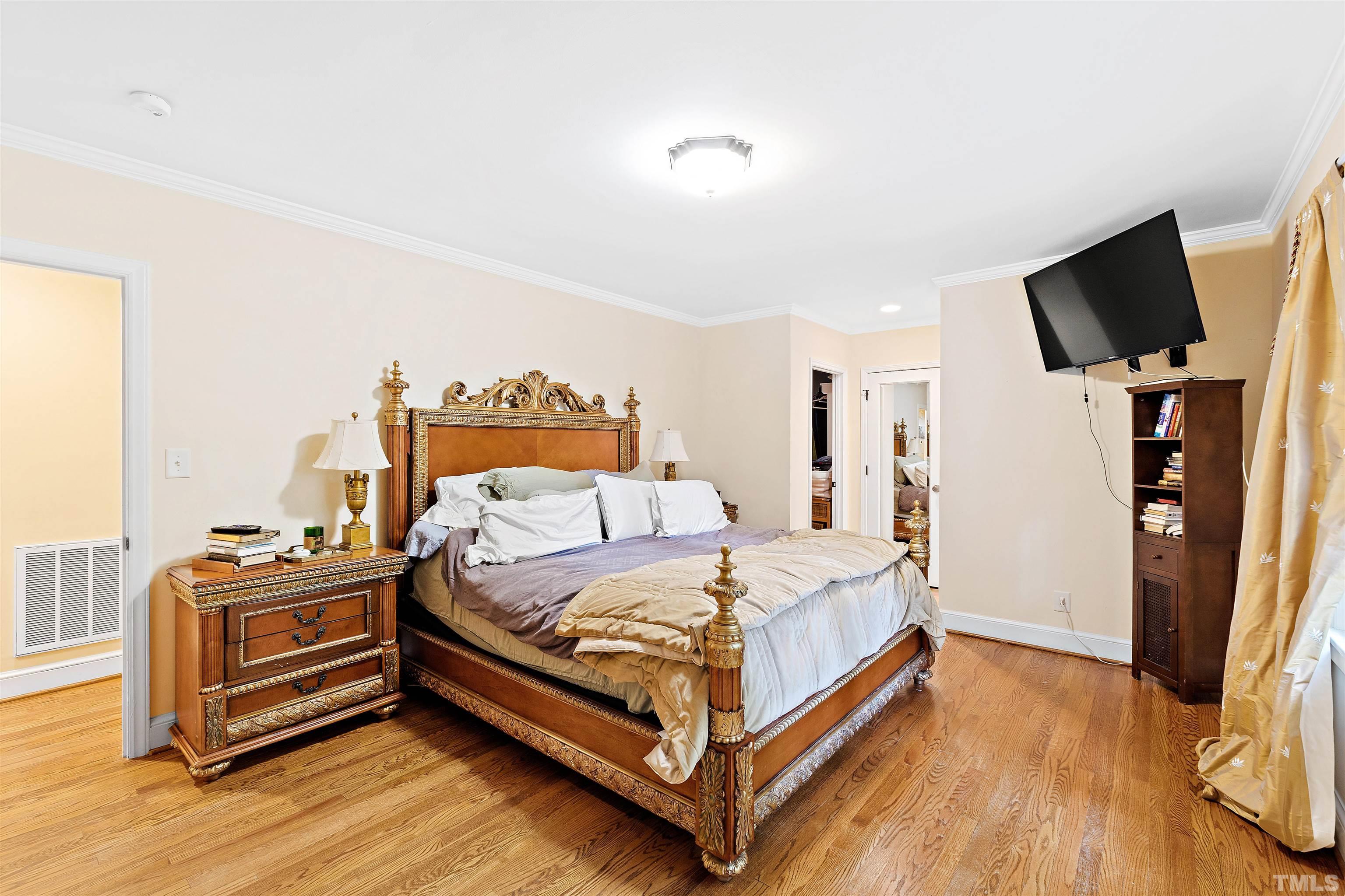 713 Brunswick Street Raleigh, NC 27609 - Photo 18 of 32 a bedroom with a bed and flat screen tv