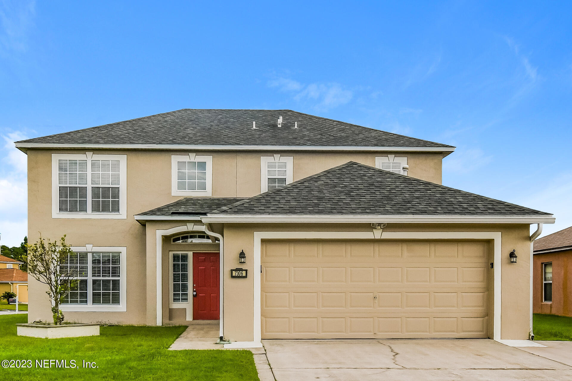 a front view of a house with a yard