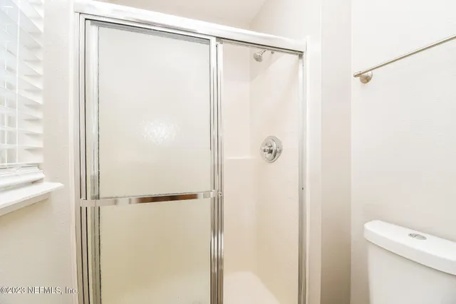 a bathroom with a shower and a toilet